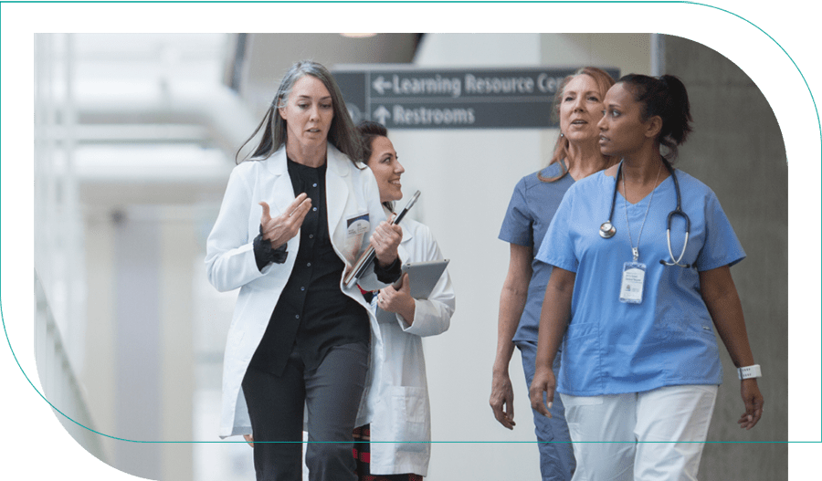 Four doctors conferring while walking outside