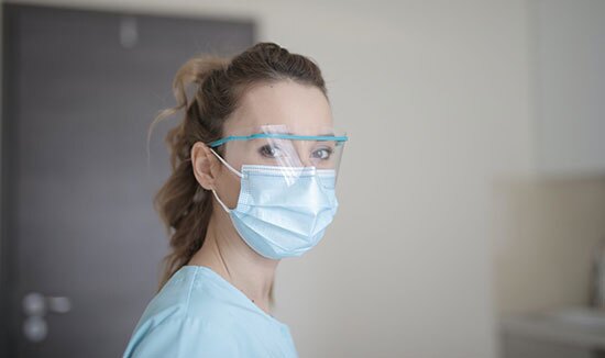 Female nurse turning to look at the camera